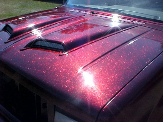 Rose Red Flake paint on hood of Ford Explorer.